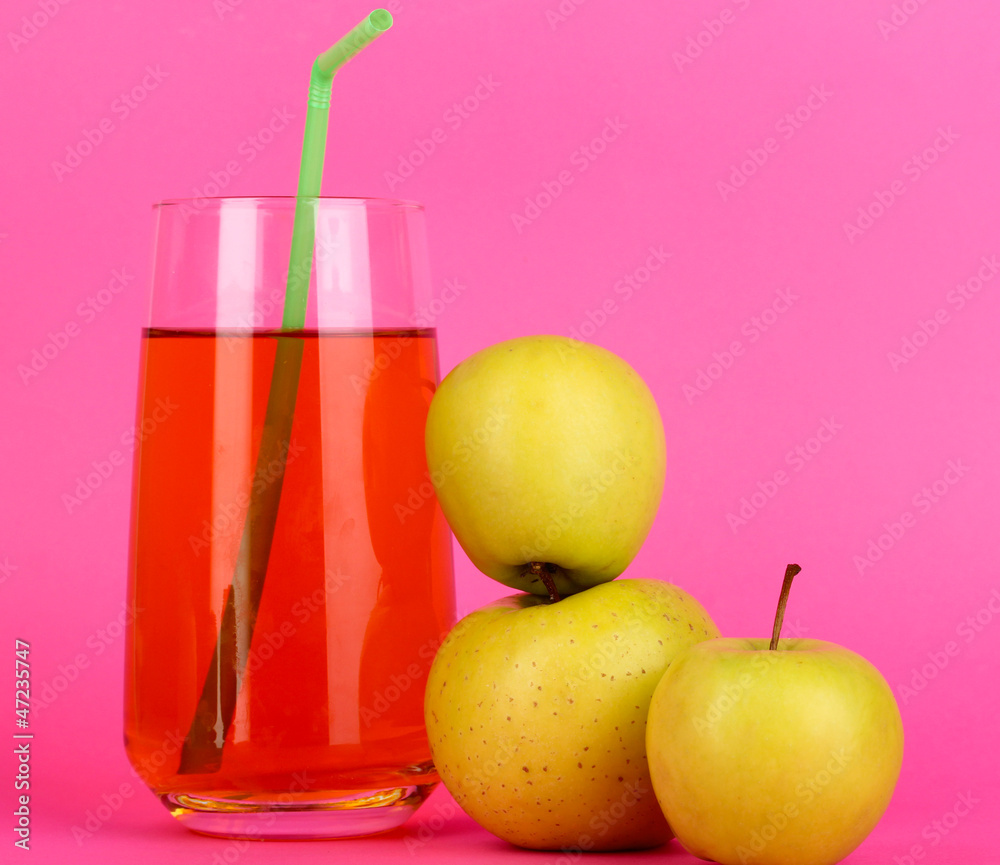 Useful apple juice with apples around on pink background Useful apple juice with apples around on pink background