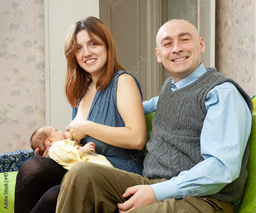 Happy parents with newborn baby photo