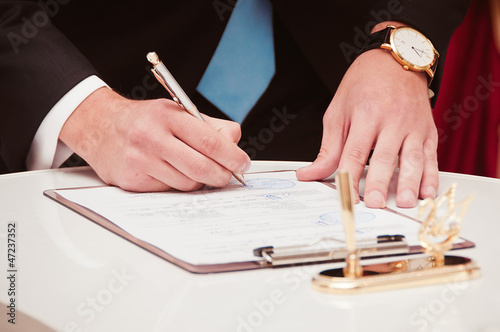 Newly-married couple signs documents