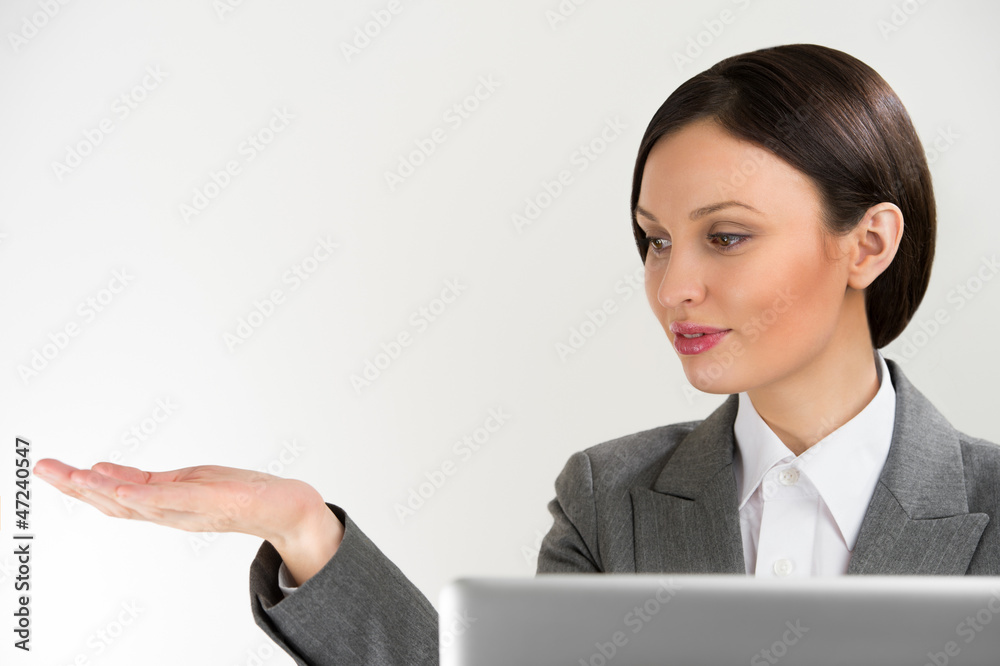 Adult pretty business woman making presentation of new product. Adult pretty business woman making presentation of new product.
