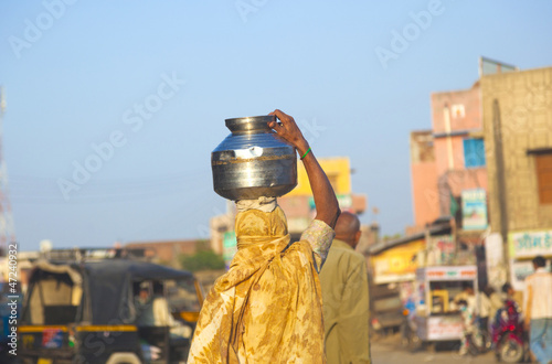 woman wearing a water pot on her head photo