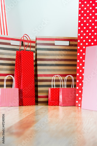 Assorted shopping and gift red paper bags - shopping and holiday