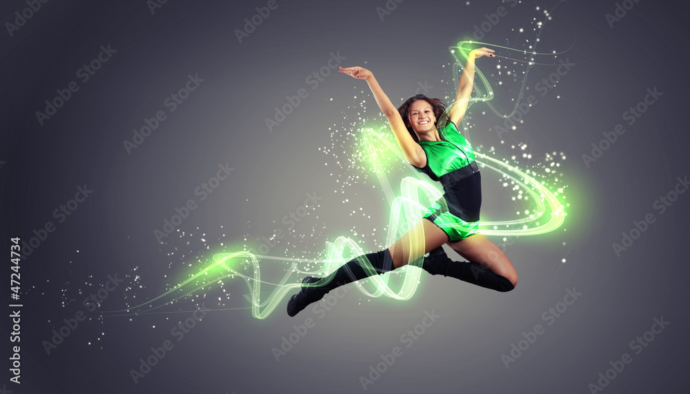 Young woman dancer. With lights effect.