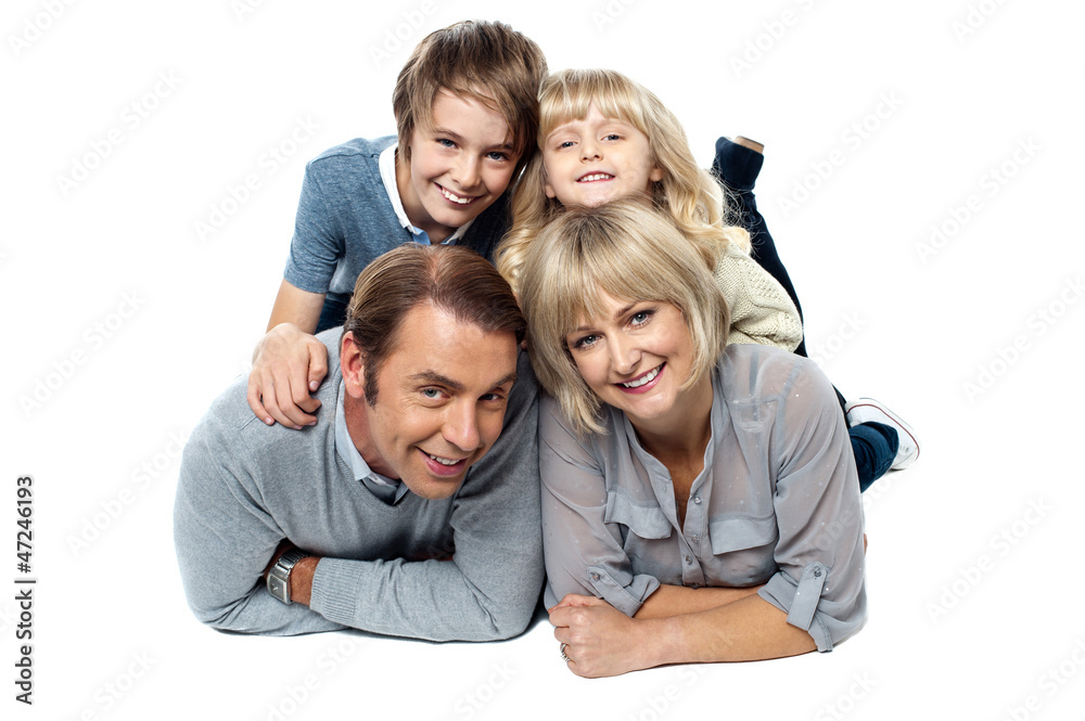 Adorable young kids piled on top of their parents