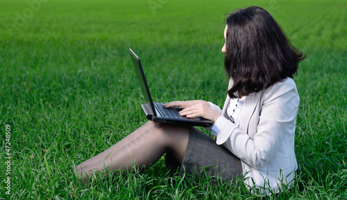 A woman in a business suit with a laptop