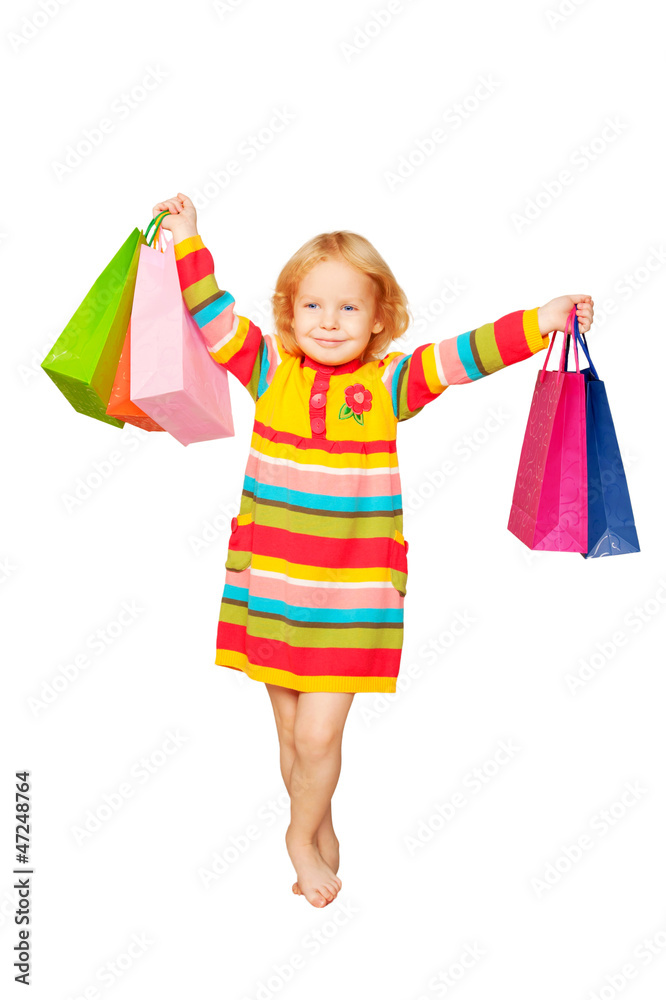 Happy fashion little blond girl with shopping bags. Happy fashion little blond girl with shopping bags.