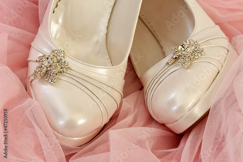 Fotografija Special bridal shoes on pink tulle - wedding white shoes
