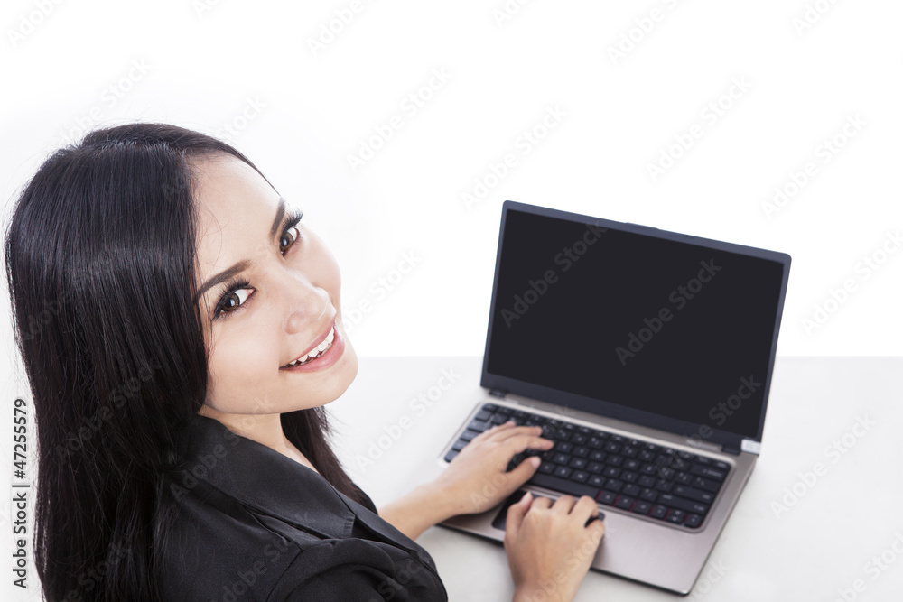 Attractive woman doing online shopping with laptop isolated Attractive woman doing online shopping with laptop isolated
