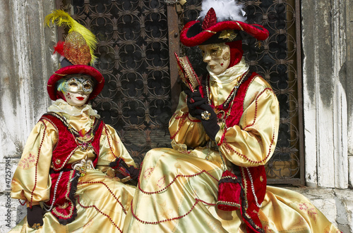 Person in Venetian costume attends the Carnival of Venice.