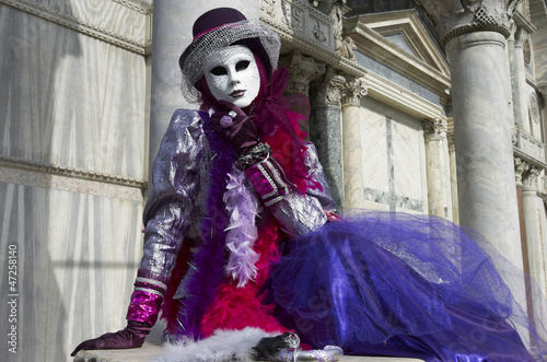 Person in Venetian costume attends the Carnival of Venice. © Lovrencg