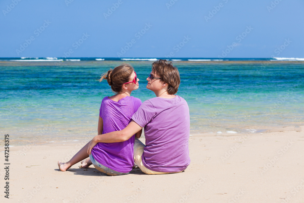 young beautiful couple on tropical bali beach.honeymoon young beautiful couple on tropical bali beach.honeymoon
