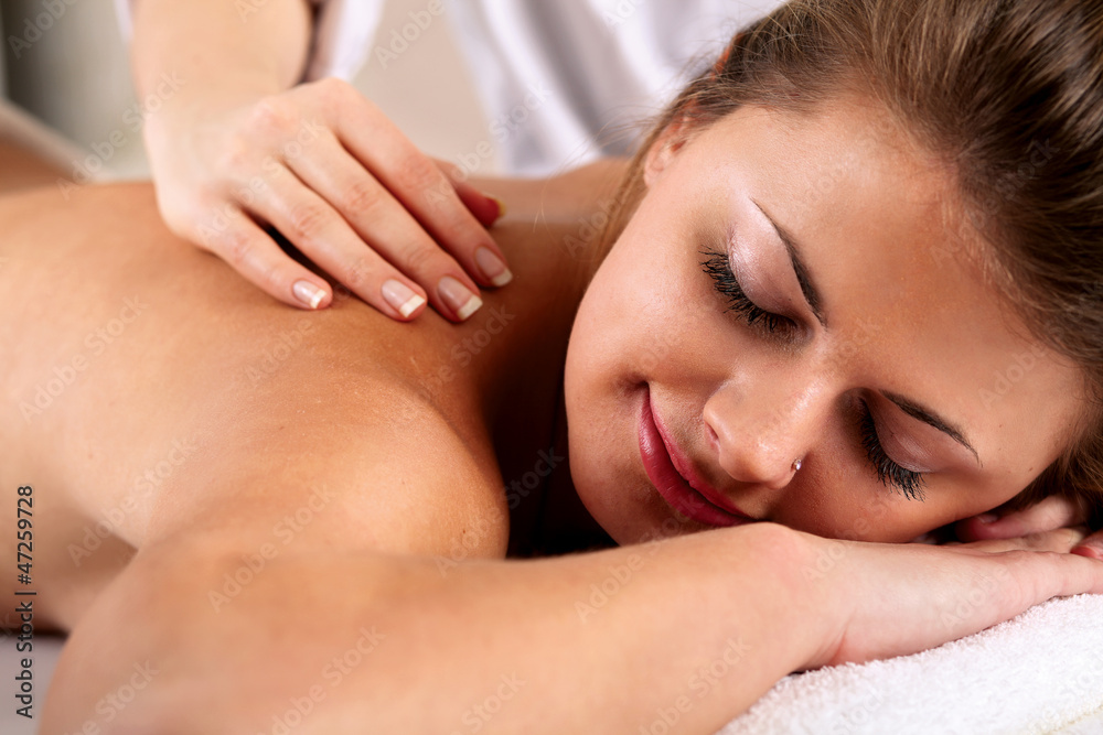 Closeup of an attractive young woman receiving massage