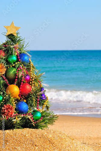 Christmas tree on the sand in the beach
