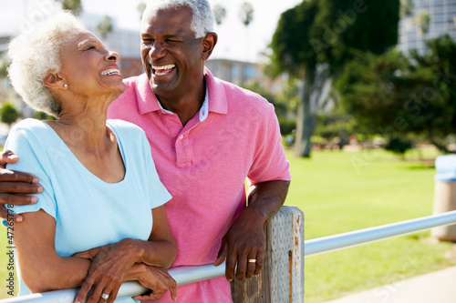 Senior Couple Walking In Park Together photo