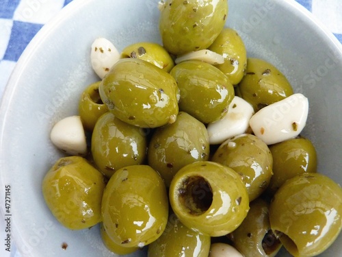 Green olives with garlic in a bowl
