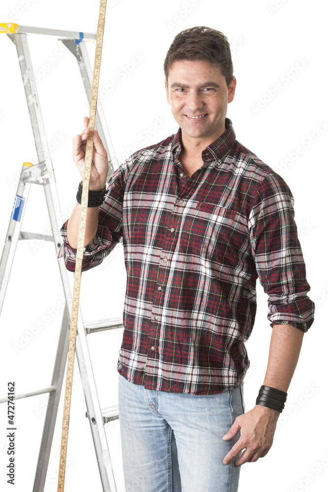 Male builder measuring with wooden rule Male builder measuring with wooden rule