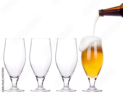 leader concept - empty and one full beer glass photo