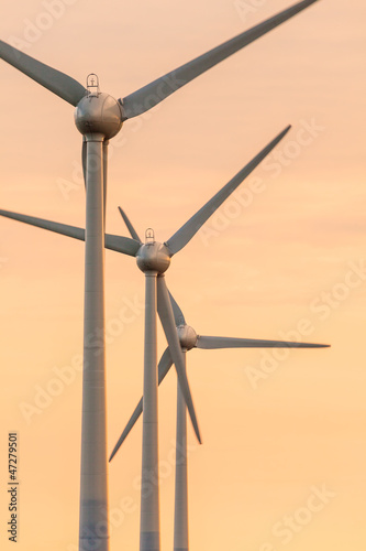 Row of wind turbines during sunset