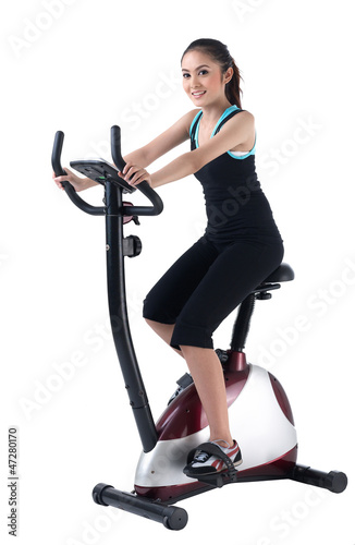 A pretty woman training on exercise bike