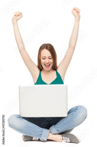 Excited woman with laptop © pikselstock