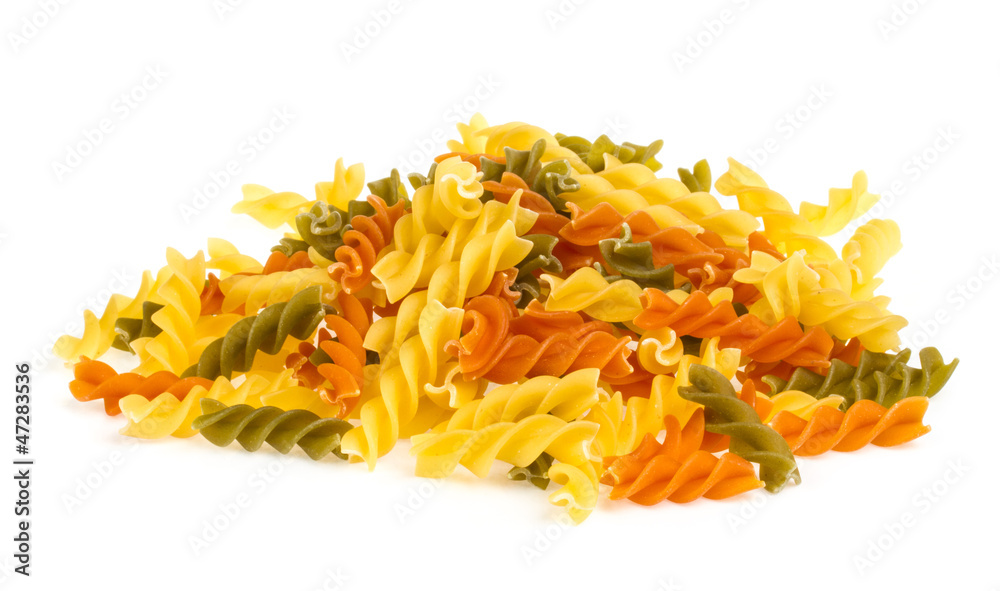 Uncooked pasta fusilli in different colours, white background Uncooked pasta fusilli in different colours, white background