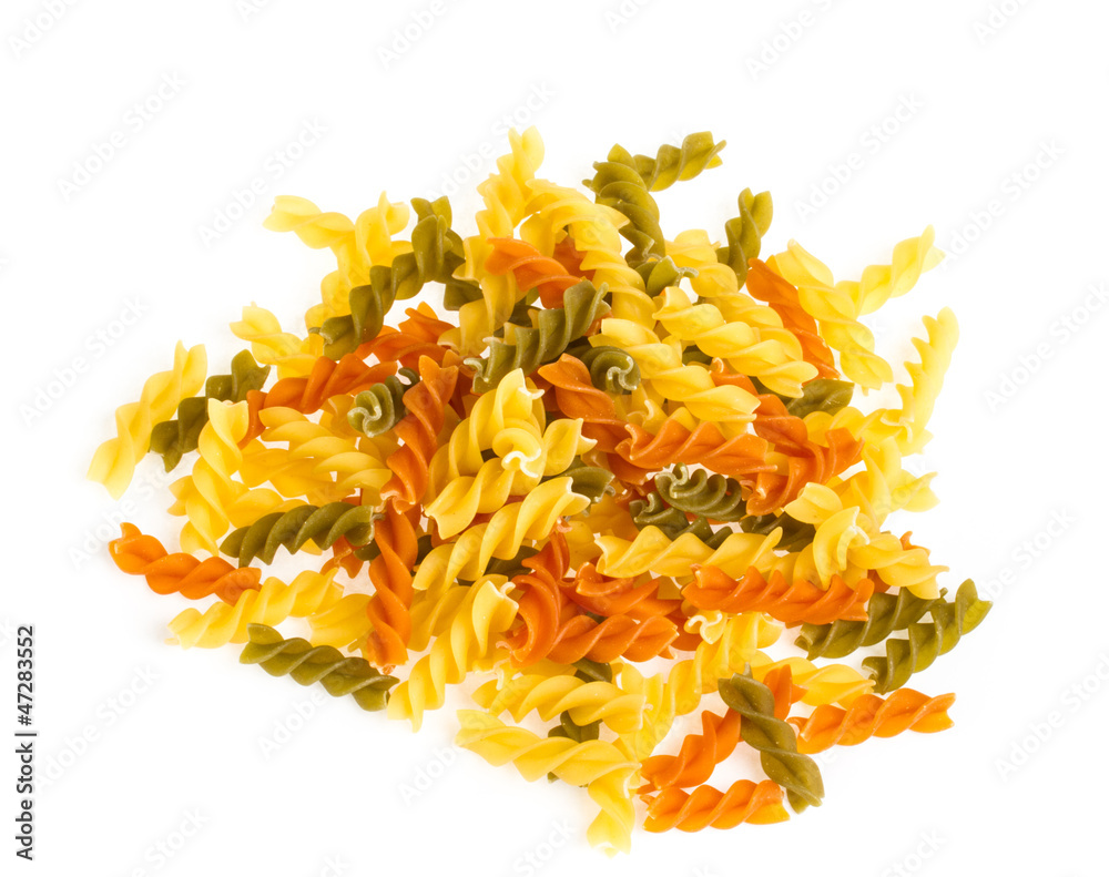 Uncooked pasta fusilli in different colours, white background Uncooked pasta fusilli in different colours, white background