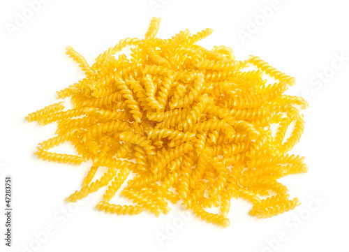 pile of fusilli pasta close up on wood background