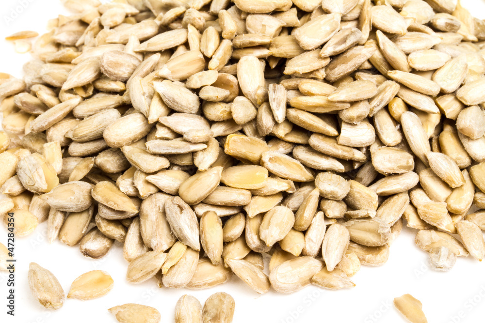fresh sunflower seeds isolated on a white background fresh sunflower seeds isolated on a white background