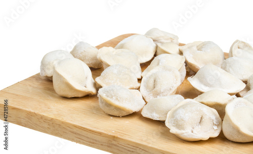 Some raw dumplings on the wooden board