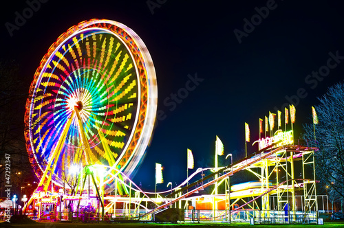 Amusement park at night - ferris wheel in motion