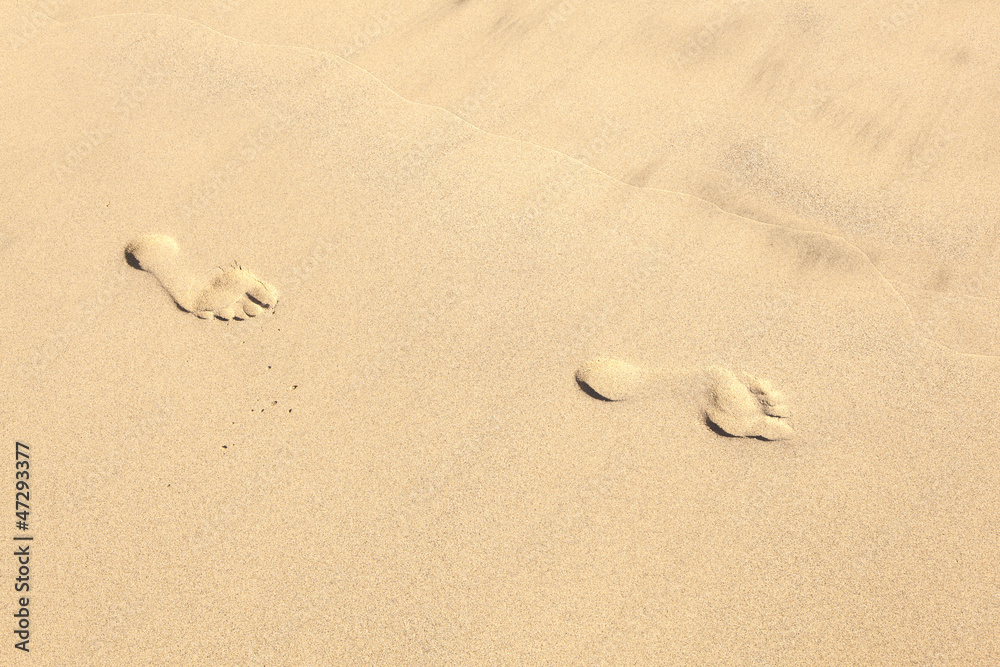 human footsteps at the clean sandy beach human footsteps at the clean sandy beach
