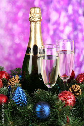 Beautiful Christmas wreath in composition with champagne