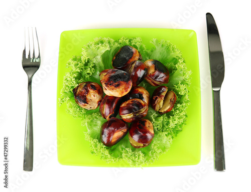 roasted chestnuts with lettuce in the green plate with fork and