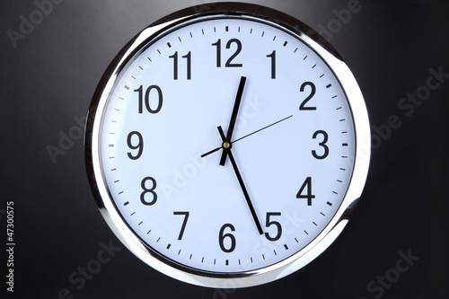 round office clock on black background