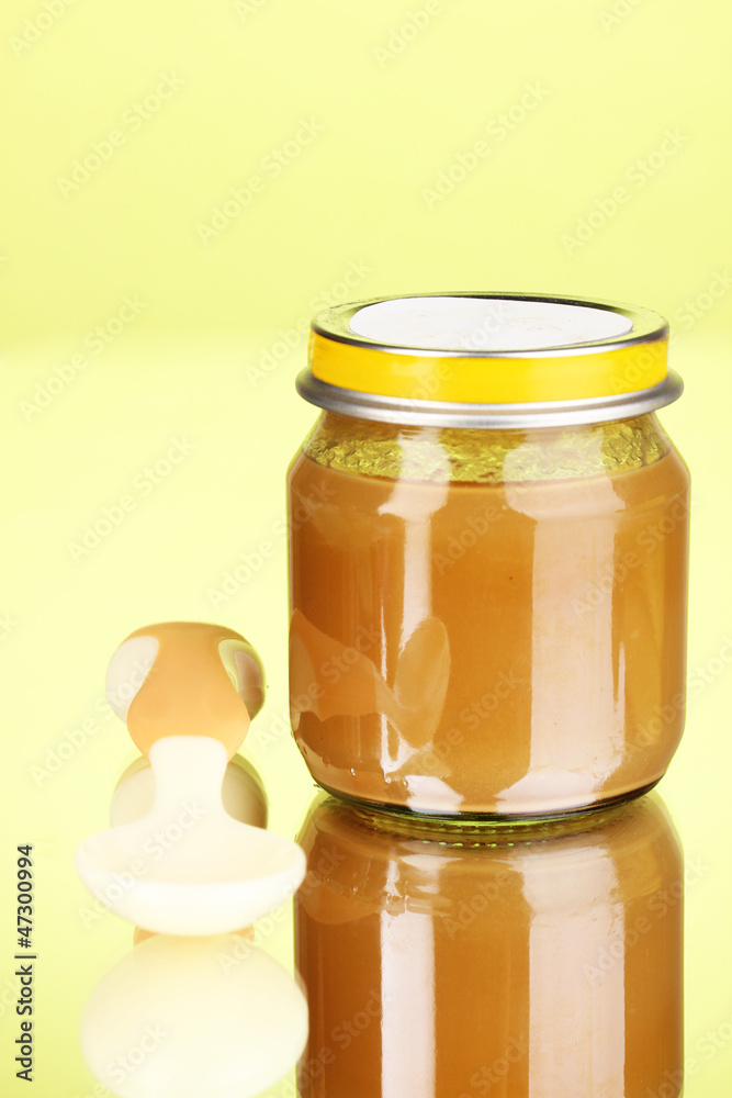 Useful and tasty baby food with beige small spoon Useful and tasty baby food with beige small spoon