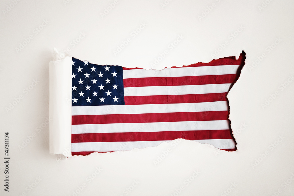 Fototapeta premium Torn paper reveals the American flag