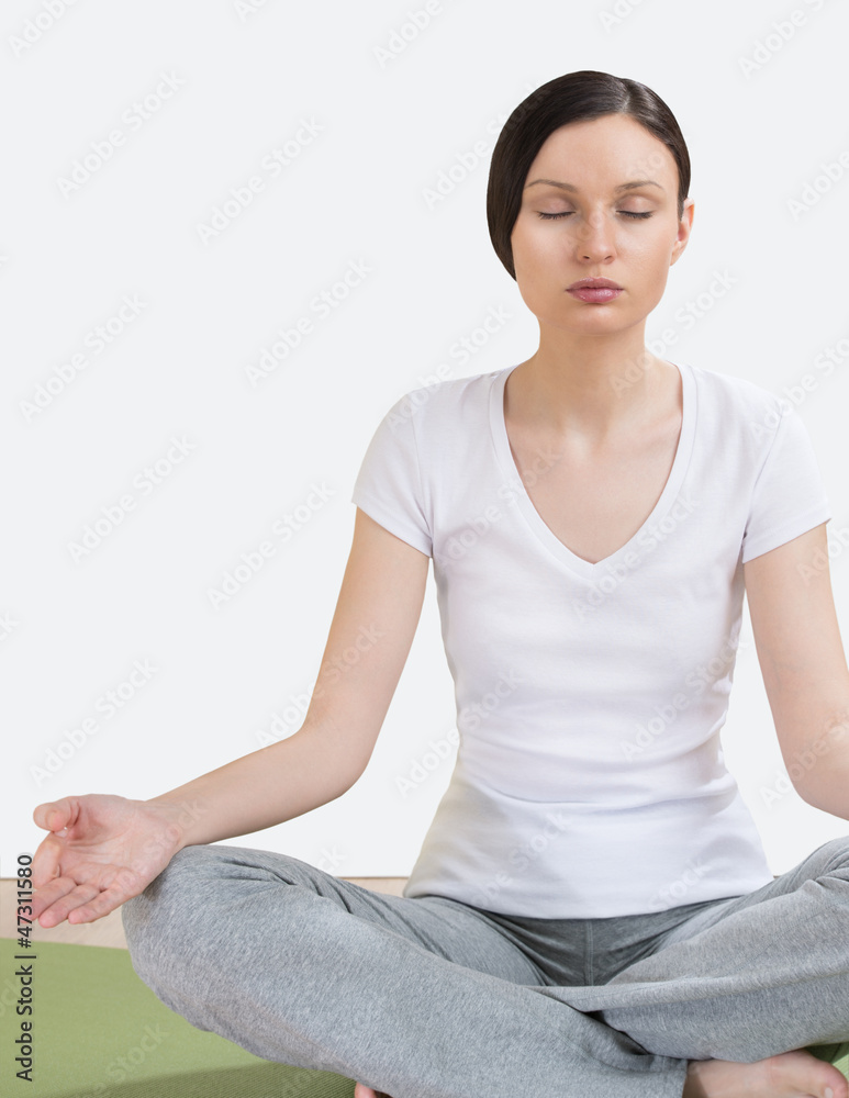 Portrait of pretty young woman doing yoga exercise on mat Portrait of pretty young woman doing yoga exercise on mat