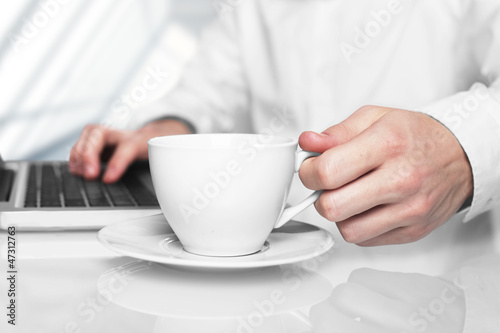 laptop and white cup