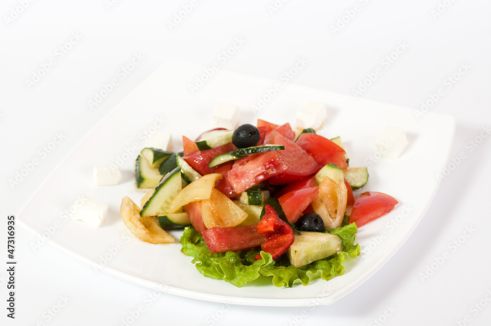 Vegetable salad on plate isolated on white Vegetable salad on plate isolated on white