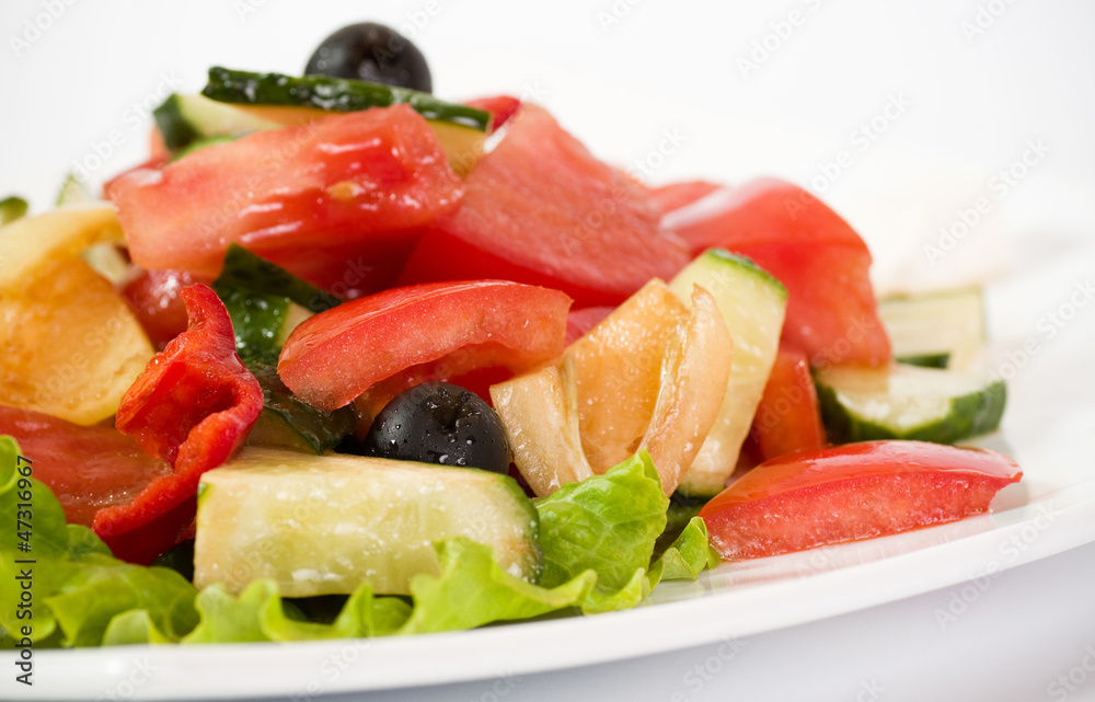 Vegetable salad on plate isolated on white Vegetable salad on plate isolated on white