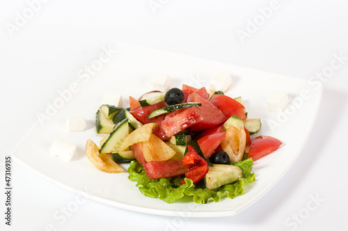 Vegetable salad on plate isolated on white