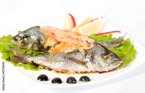 Fried fish garnished on sliced olive and sauce