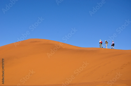 People walking on dune of Namib desert  hiking in South Africa