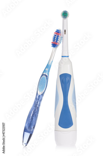 Electric and traditional toothbrushes isolated on white.