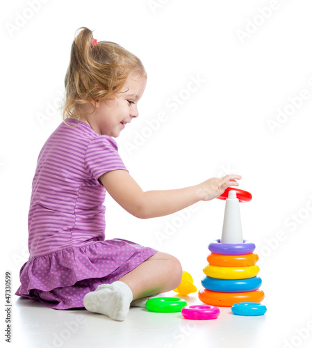 little child playing with colorful toys, isolated over white