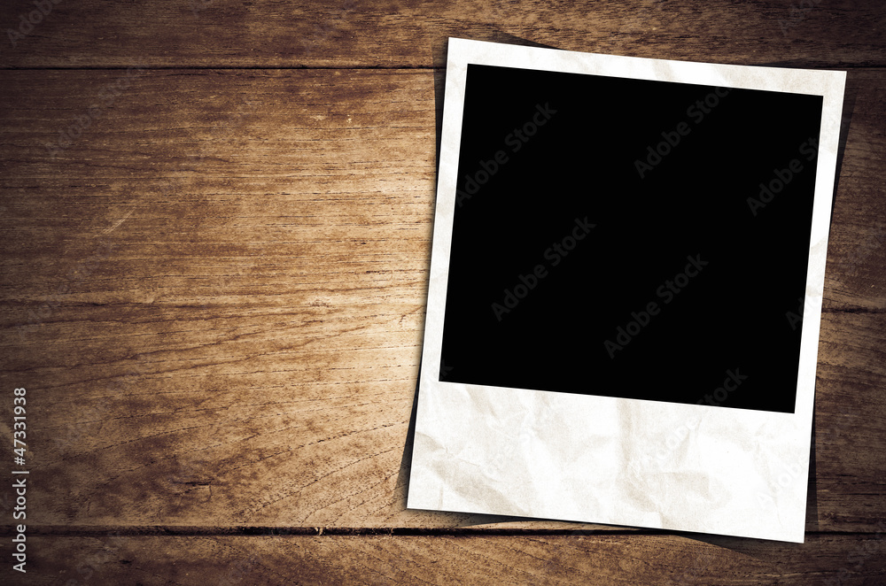 Old photo frame on wood background Old photo frame on wood background