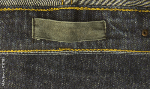 Obraz na plátne fabric jeans label sewed on a blue jeans.