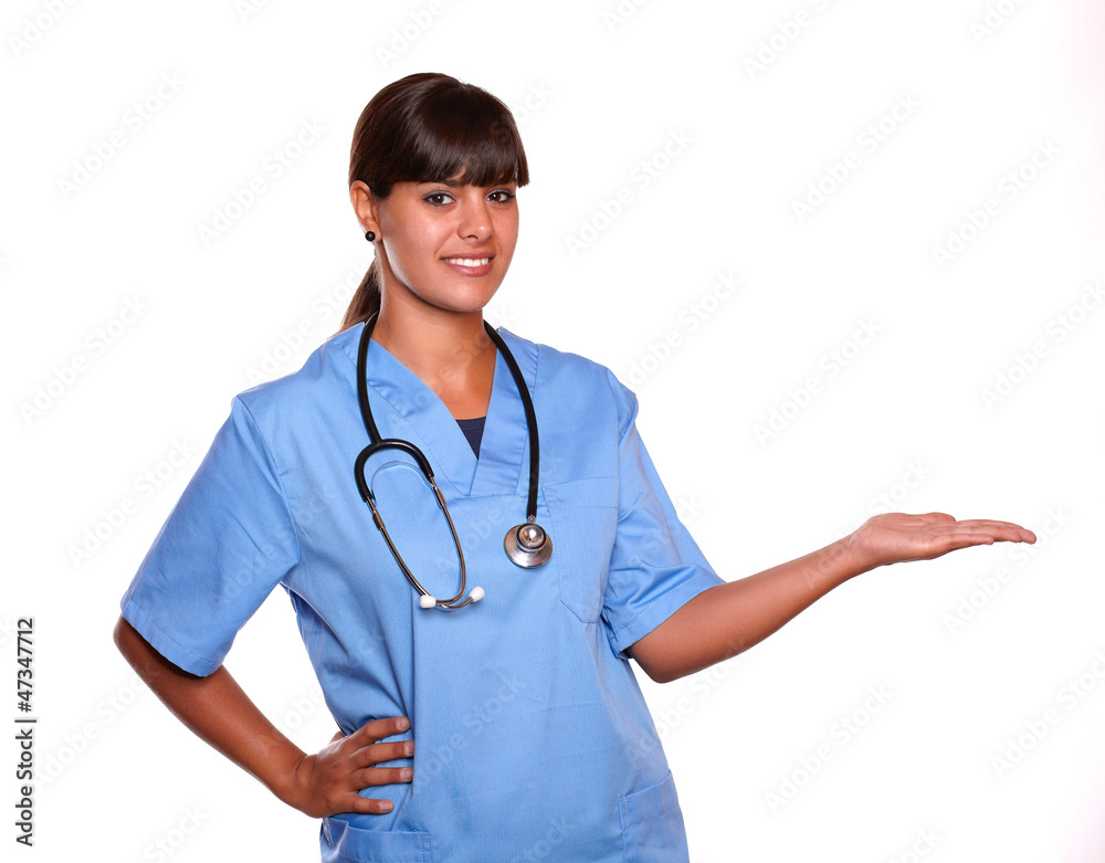 Pretty nurse holding out her left palm copyspace Pretty nurse holding out her left palm copyspace