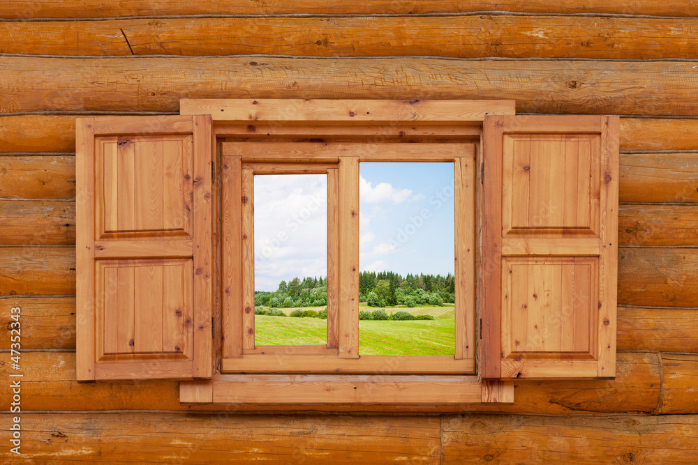 field is visible from a window in the wooden rural house field is visible from a window in the wooden rural house