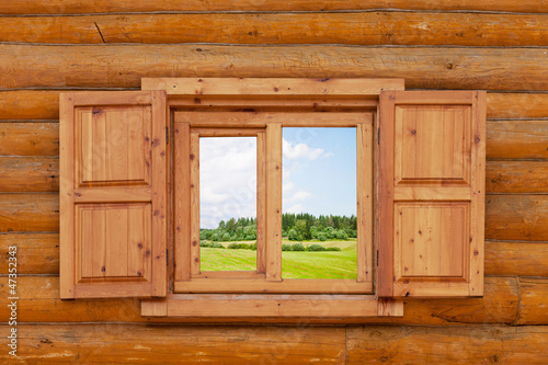  field is visible from a window in the wooden rural house